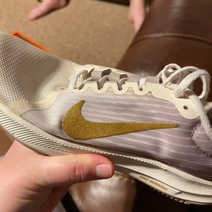 White and gold Nikes